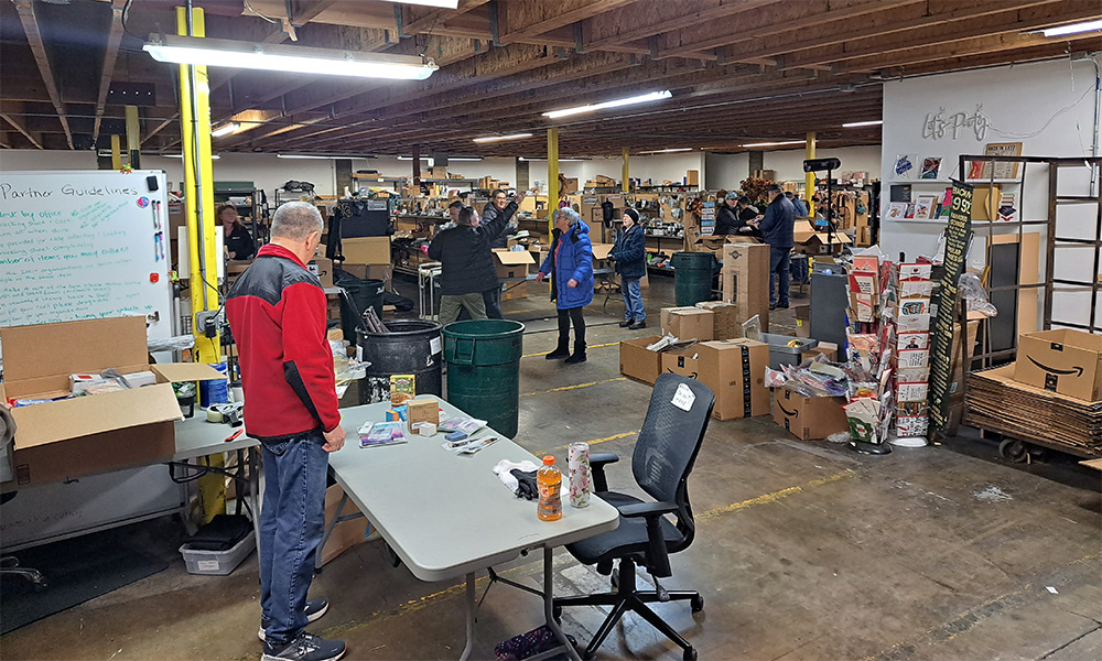 The Good360 Warehouse with workers organizing boxes and goods for people