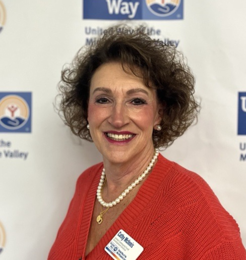 Staff profile picture: Kathy McInnis in front of a United Way step and repeat